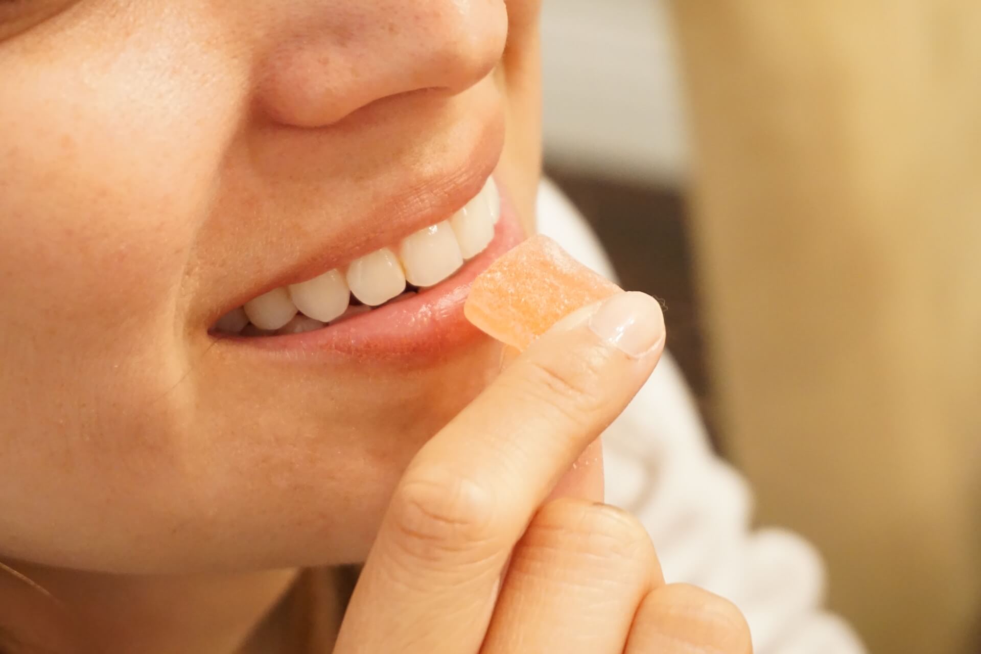 Woman about to eat a Delta 10 gummy